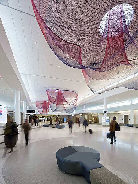 Janet Echelman “Every Beating Second” 2011, total area about 15,000 sq. ft. (28.5? x 83.5? x 176.5?), installation view at San Francisco International Airport, powder-coated steel, colored fiber, skylights, terrazzo floor, and computer-programmed airflow and colored light, braiding, knotting, netting. CREDITS: Studio Echelman Team: Becky Borlan (Project Manager, Color Specialist, Photographs), Daniel Lear (Design Support), Philip Speranza (Design Support), Melanie Rose Peterson (Design Support), Yan Yan Mao (Photographs, On-site net fabrication), Rachel Kaede Newsam (Design Support). Architect for Art: Public Architecture & Planning (San Diego). Terminal Architecture: Gensler (Los Angeles). Engineer: Buro Happold (New York). Design Engineer: Peter Heppel Associates (Paris). Consultants: Speranza Architecture (New York). Lighting Design: Lam Partners (Cambridge, MA). Programming Consultant: Zoll Design (Boston). Photo: BruceDamonte.