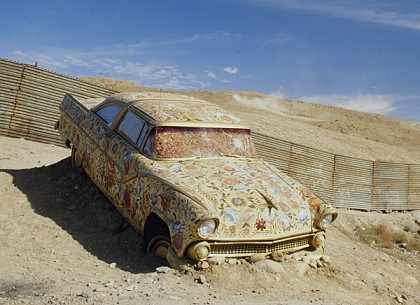 Betsabeé Romero "Car/Ayate" (at US-Mexico border) Cloth-covered auto painted with roses 169.3" x 82.7" x 55.1",1997. "InSite Biennial," Tijuana, Mexico. Daros Collection, Switzerland.
