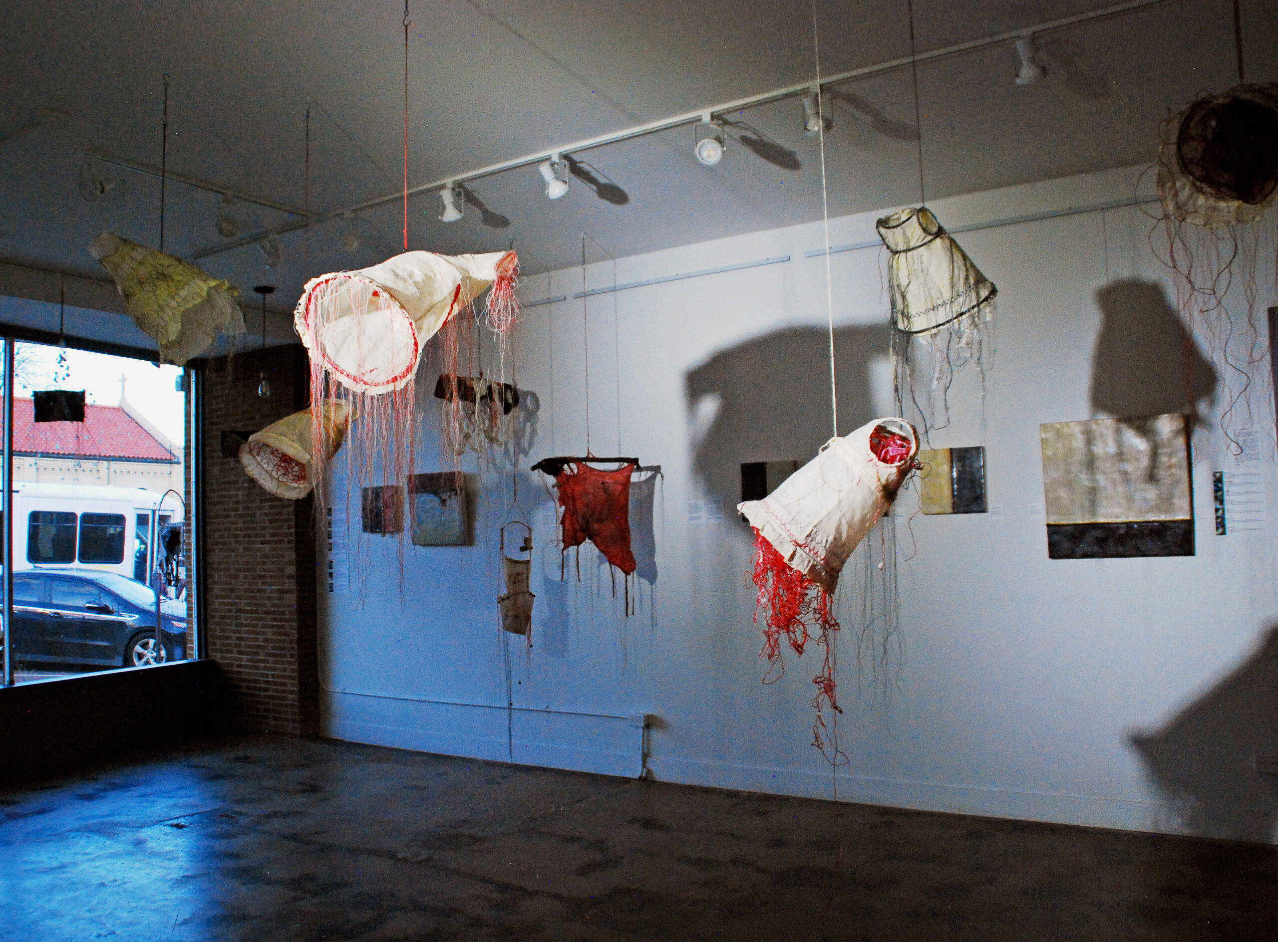 FLIGHT OF THE INNOCENTS, Installation view, from the “The Clothes We Wear” Exhibition, Kreuser Gallery.This installation of seven suspended sculptures conceptualizes the impact of climate change on women and children forced to flee from homelands impacted by drought and flood.